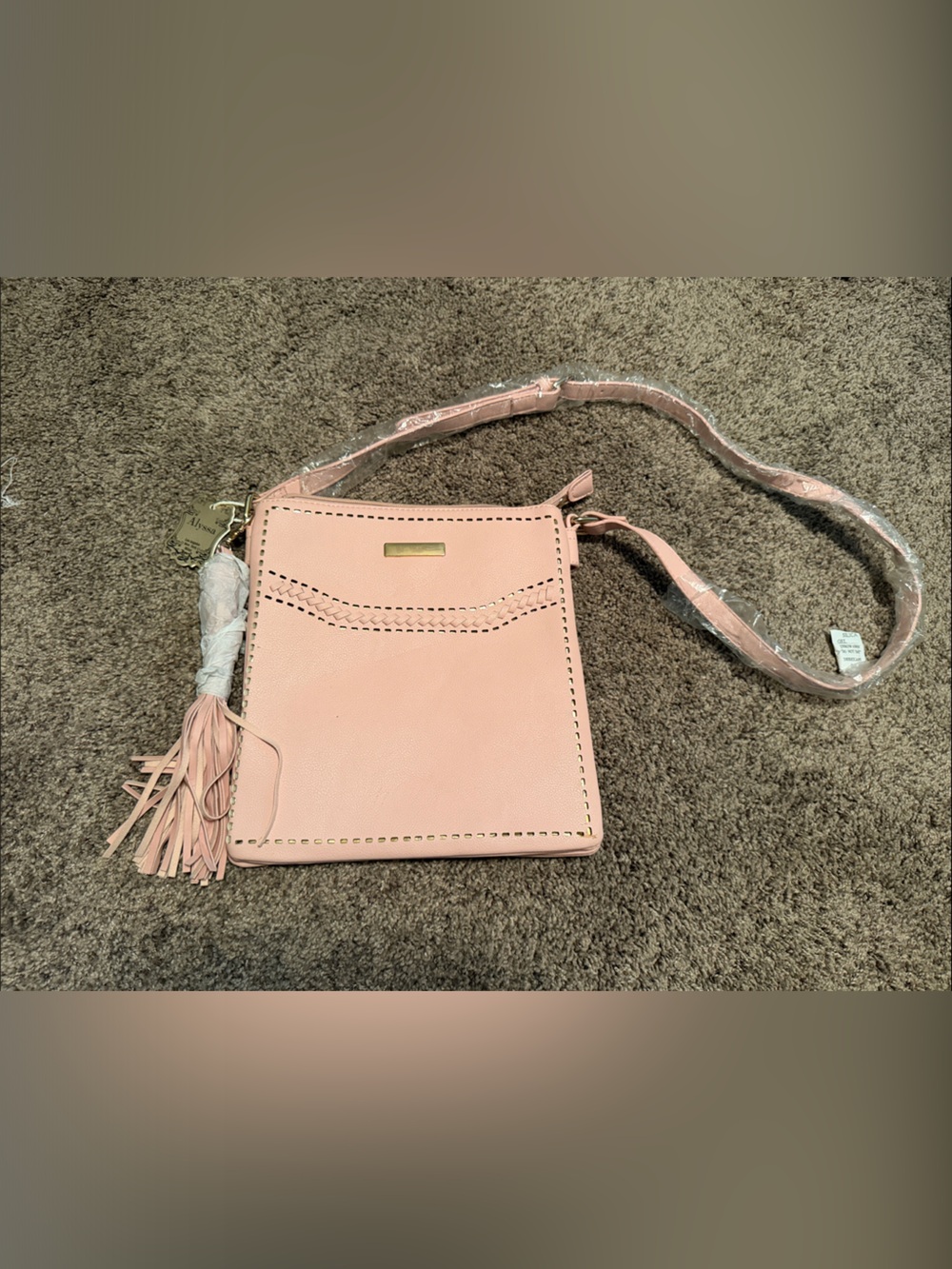 Compact Pink Crossbody Bag with Tassel Accent